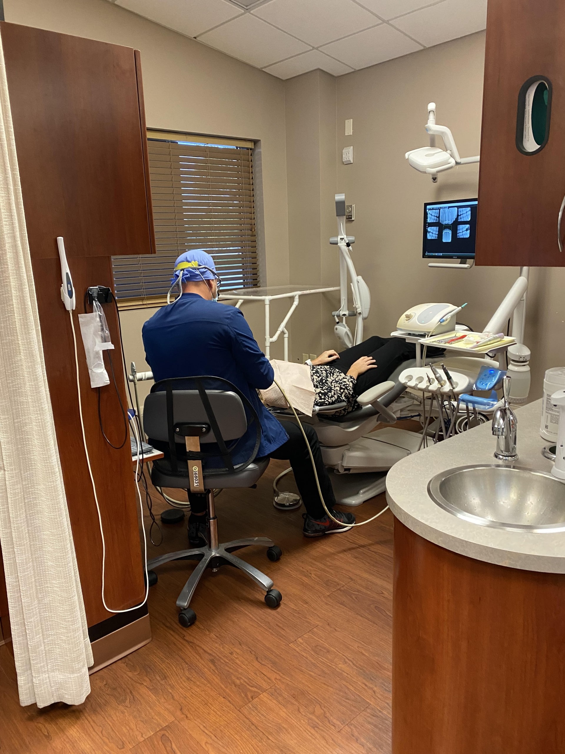 Dr. Firouzian assisting a dental implant patient with a procedure in his Columbus, Ohio dental office